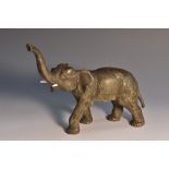 An Austrian cold painted bronze, of an elephant, standing four square, with trunk raised, 17cm long,