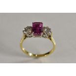 A sapphire and diamond trilogy ring, central octagonal cut pink sapphire, measuring 8.23mm x 5.