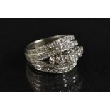 A diamond cluster ring, central quintet of graduated round brilliant cut diamonds,