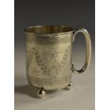 A Victorian silver cylindrical christening mug, engraved with swags and wrigglework, scroll handle,