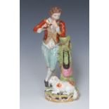 A Derby figure, of a shepherd standing, leaning on a tree stump, playing the flute,