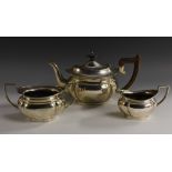 A George V silver three piece oval tea service, comprising teapot, milk jug and sugar basin,