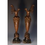 A pair of bronze and serpentine classical slender vasular ewers, in Etruscan style,