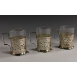 A set of three Turkish silver tea glass holders, each pierced and engraved with arms,