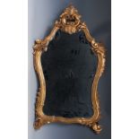 A 19th century Rococo Revival giltwood and gesso shaped looking-glass,