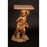 A 19th century giltwood and gesso figural statuary pedestal, carved as a scantily clad putto,