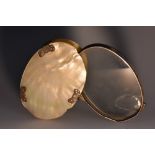 A George III silver and mother of pearl gentleman's oval pocket lens, reeded border, 9cm wide, c.