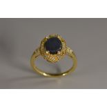 A black opal and diamond ring, central oval black opal, flashing violet, green and blue colour play,