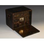 A Namban lacquer rectangular table cabinet, fall front enclosing an arrangement of drawers,