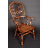 A 19th century elm Windsor elbow chair,