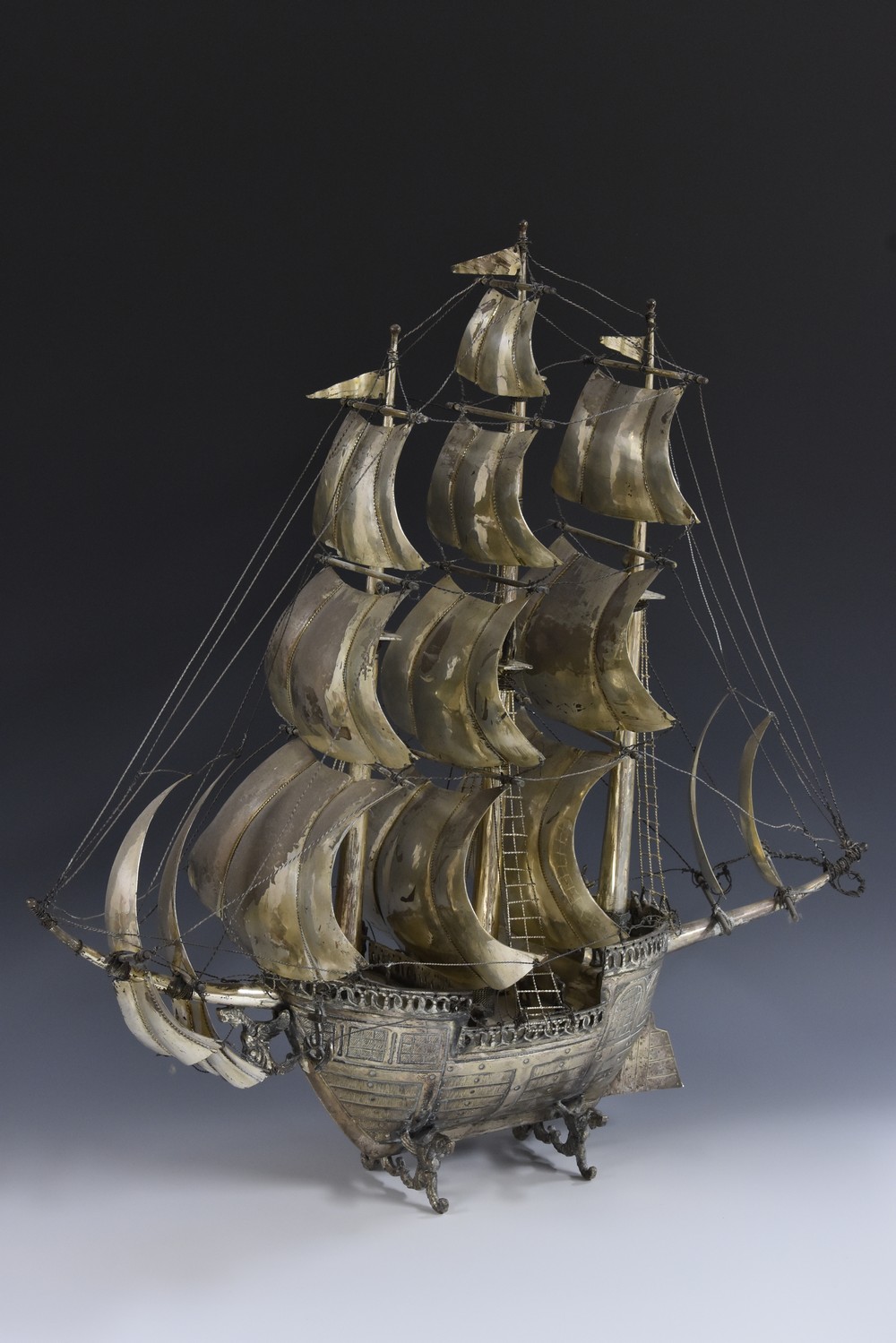 A large Continental silver coloured metal nef, the three masts with billowing sails,