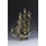 A large Continental silver coloured metal nef, the three masts with billowing sails,