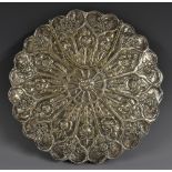 A Turkish silver shaped circular mirror, chased with lotus and other flowers, 22cm diam,