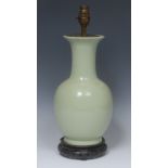 A Chinese celadon ovoid vase, flared rim, 29cm high, later mounted as a lamp, hardwood stand,