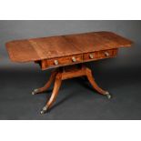 A Regency ebony crossbanded mahogany canted rectangular sofa table, turned supports and stretchers,