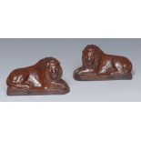 A pair of Derbyshire brown salt glazed stoneware models, of recumbent lions, to left and right, 14.