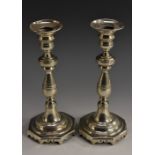 A pair of Portuguese cast silver candlesticks, of seamed construction, broad sconces,