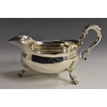 A large George II silver sauceboat, acanthus-capped double scroll handle, wavy everted rim,