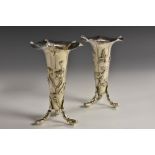 A pair of Chinese silver three-footed trumpet shaped vases, each applied with lotus,