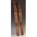 A pair of 19th century oak figural pilasters, each carved with a herm above a boss, pendent tassel,