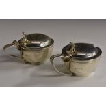 A pair of George V silver circular mustards, hinged domed covers with Onslow thumbpieces,