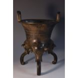 A Chinese patinated bronze ding censer, cast in the archaic manner, square lug handles,