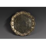 A George II shaped circular tray, he field engraved with crest within scrolling acanthus leaves,