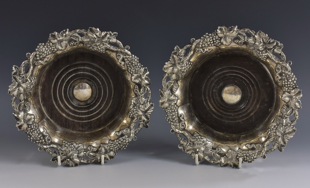 A pair of post-Regency Sheffield plate fluted shaped circular wine coasters, fruiting vine borders,