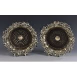 A pair of post-Regency Sheffield plate fluted shaped circular wine coasters, fruiting vine borders,