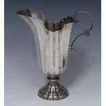An 18th century Italian silver fluted helmet shaped ewer, double-scroll handle, domed foot,
