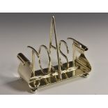 A Victorian silver novelty five bar toast, the divisions spelling the word Toast, scroll ends,