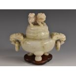 A Chinese mutton fat jade censer and cover, temple lion finial, loose-ring mask handles to sides,