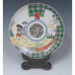 A Chinese shaped circular shallow dish,