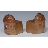 A pair of Derbyshire brown salt glazed stoneware window stops or furniture rests,