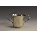 A George III silver bell shaped porringer, quite plain, reeded scroll handles, 7cm high,