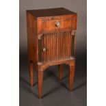 An early 19th century Dutch mahogany night table, frieze drawer above a tambour-fronted compartment,