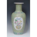 A Chinese ovoid vase, painted in polychrome enamels with a ribbon-tied basket of flowers and fruit,