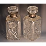A pair of Elizabeth II silver mounted cut glass canted square spirit decanters,