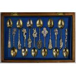 A set of twelve Chinese silver teaspoons, harlequin finials cast as a robed elder,