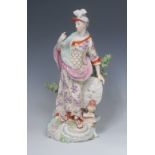 A Derby Patch Mark figure, Minerva, The Goddess of Wisdom, she stands wearing a feathered helmet,