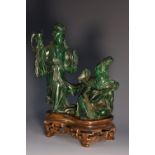 A Chinese malachite carving, of two courtly ladies, one stands proffering libation,