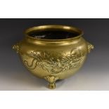 A large 19th century Chinese bronze censer, cast with a ferocious dragon amongst scrolling clouds,