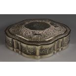 An Indian/Burmese silver shaped oval box, chased with elephants, lion and scrolling foliage,