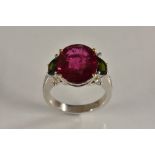 A tourmaline and diamond ring, large central round rubellite tourmaline, approx 7.