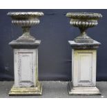A pair of Regency style composition shallow campagna half-fluted garden urns,