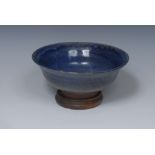 A Japanese monochrome stoneware flared circular bowl, glazed in mottled tones of purple, 18cm diam,