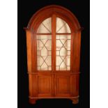 A 19th century mahogany floor standing corner cabinet, arched cornice, applied with fret,