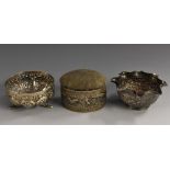 An Anglo-Indian silver oval pin cushion, the base cast and chased with a panorama of village life,