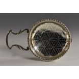 A George II silver orange strainer, gadrooned rim, leafy lug handle, 16.