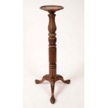 A 19th century mahogany statuary pedestal, dished circular top, lotus-carved fluted baluster pillar,